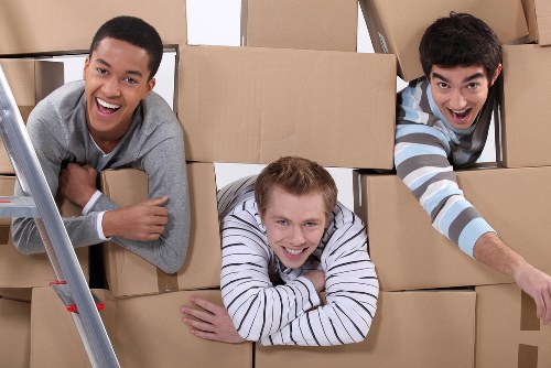 Packed boxes and furniture ready for house removals in a local home