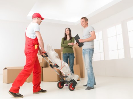Boxes and furniture being loaded into a van for transport
